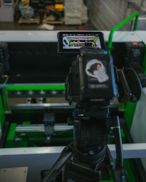 Close-up of detailed video documentation equipment capturing factory workflow.