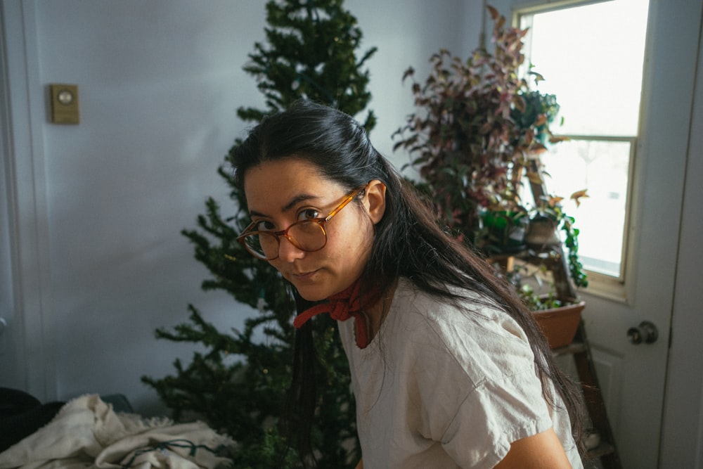 a woman wearing glasses and a bow tie