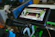 Technician providing remote support with multiple screens showing system diagnostics.