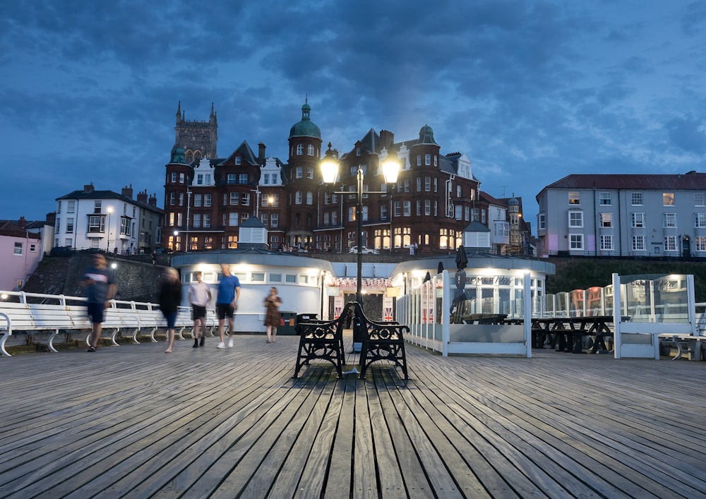 a group of people sitting on top of a wooden deck