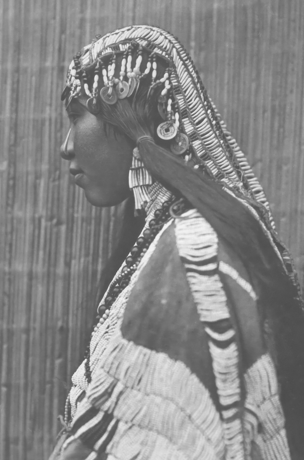 an old photo of a woman wearing a headdress