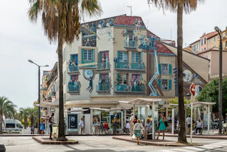 Local artists painting a mural inspired by classic movie scenes on the theater wall.