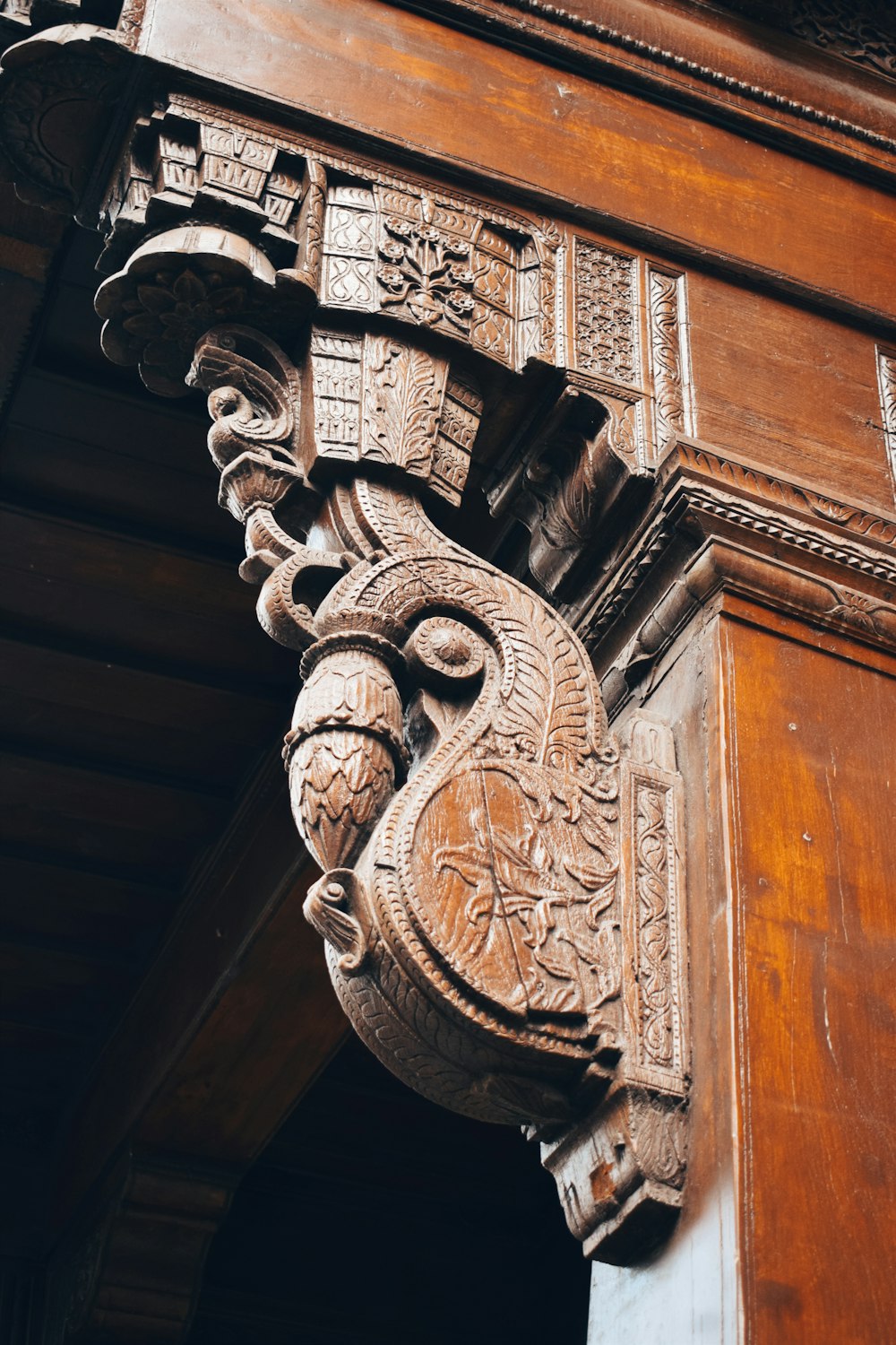 a close up of a wooden building with carvings on it