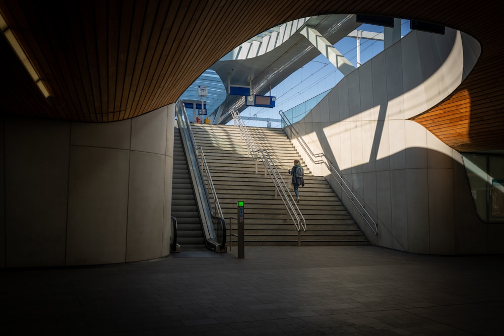 an escalator in a building with stairs leading up to it