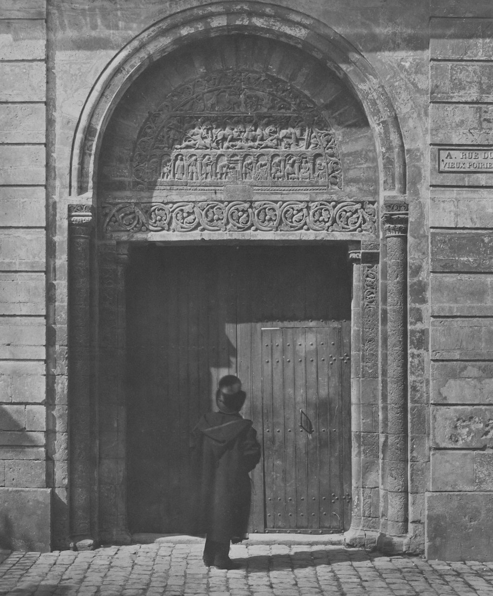 a woman standing in front of a doorway