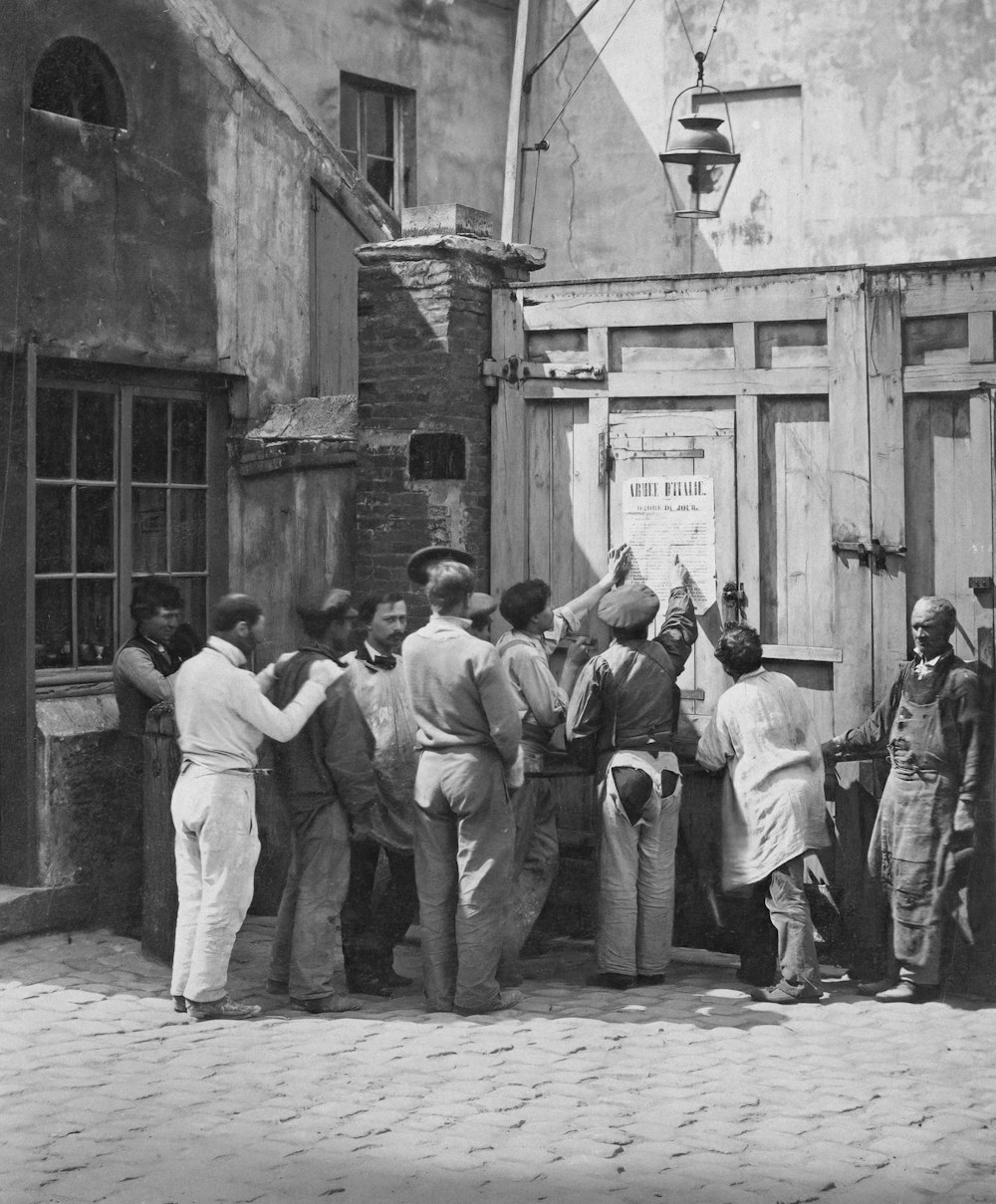 a group of people standing outside of a building