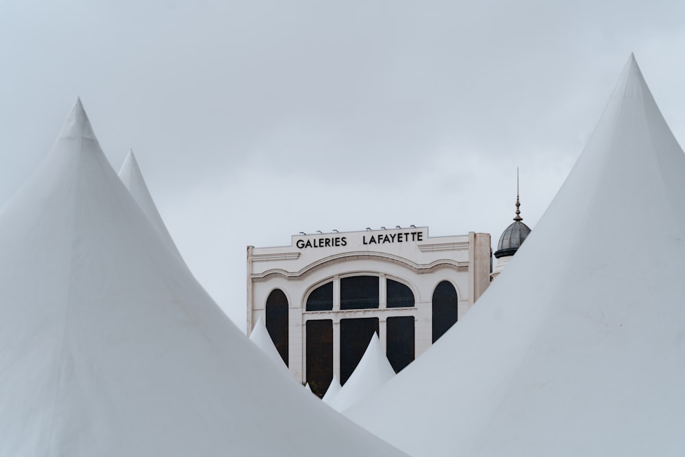 a building with a clock on top of it covered in snow
