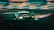 A sleek, high-performance racing car is speeding around a track. The car is predominantly black with green and neon accents, featuring various logos and sponsorship decals. Motion blur emphasizes its speed, while the background track and barriers add to the dynamic scene.