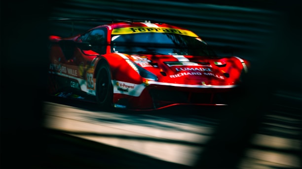 A sleek red sports car speeding down an open highway, symbolizing fast business growth.