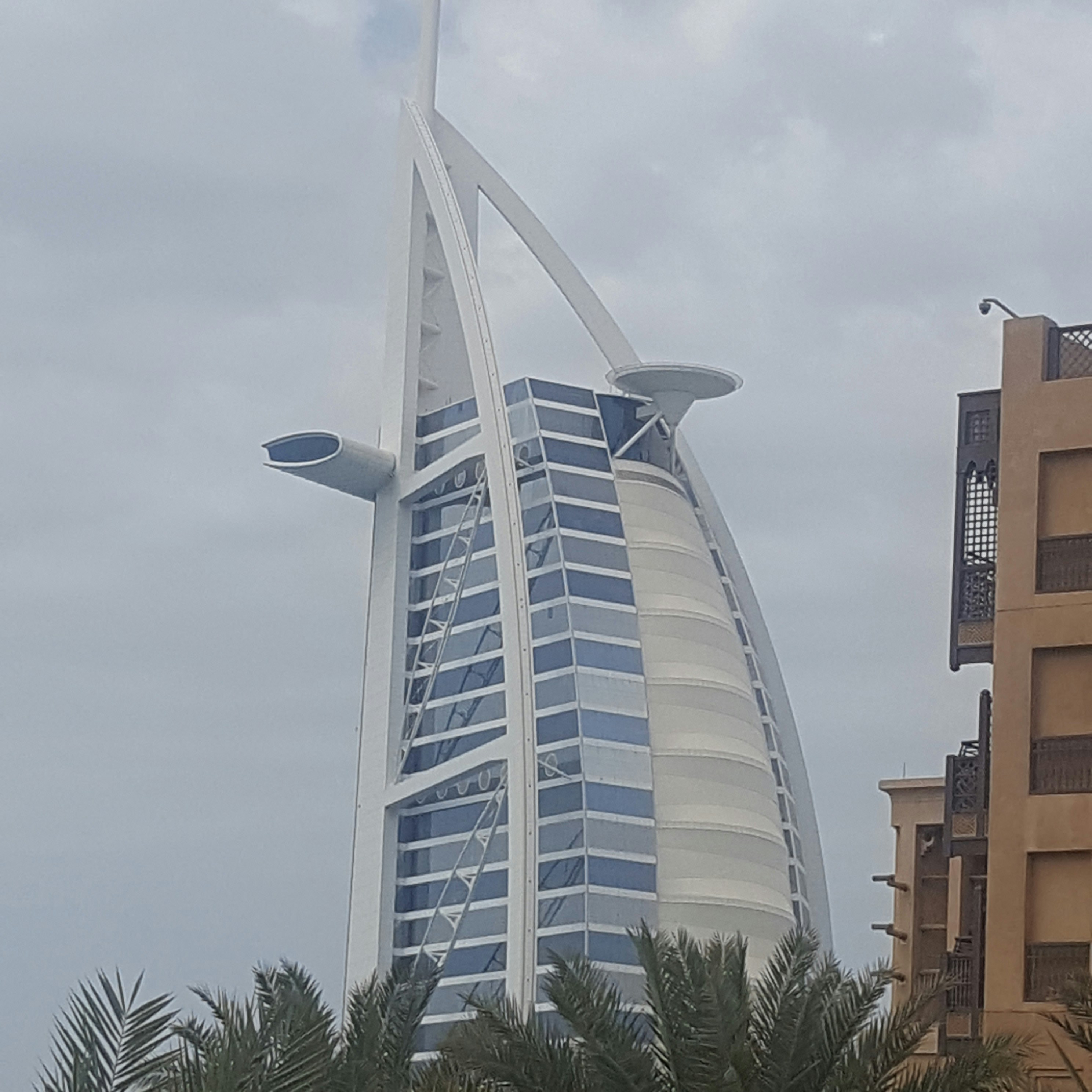 Dubai Burj Al Arab luxury hotel sail shaped architecture at dusk purple sky