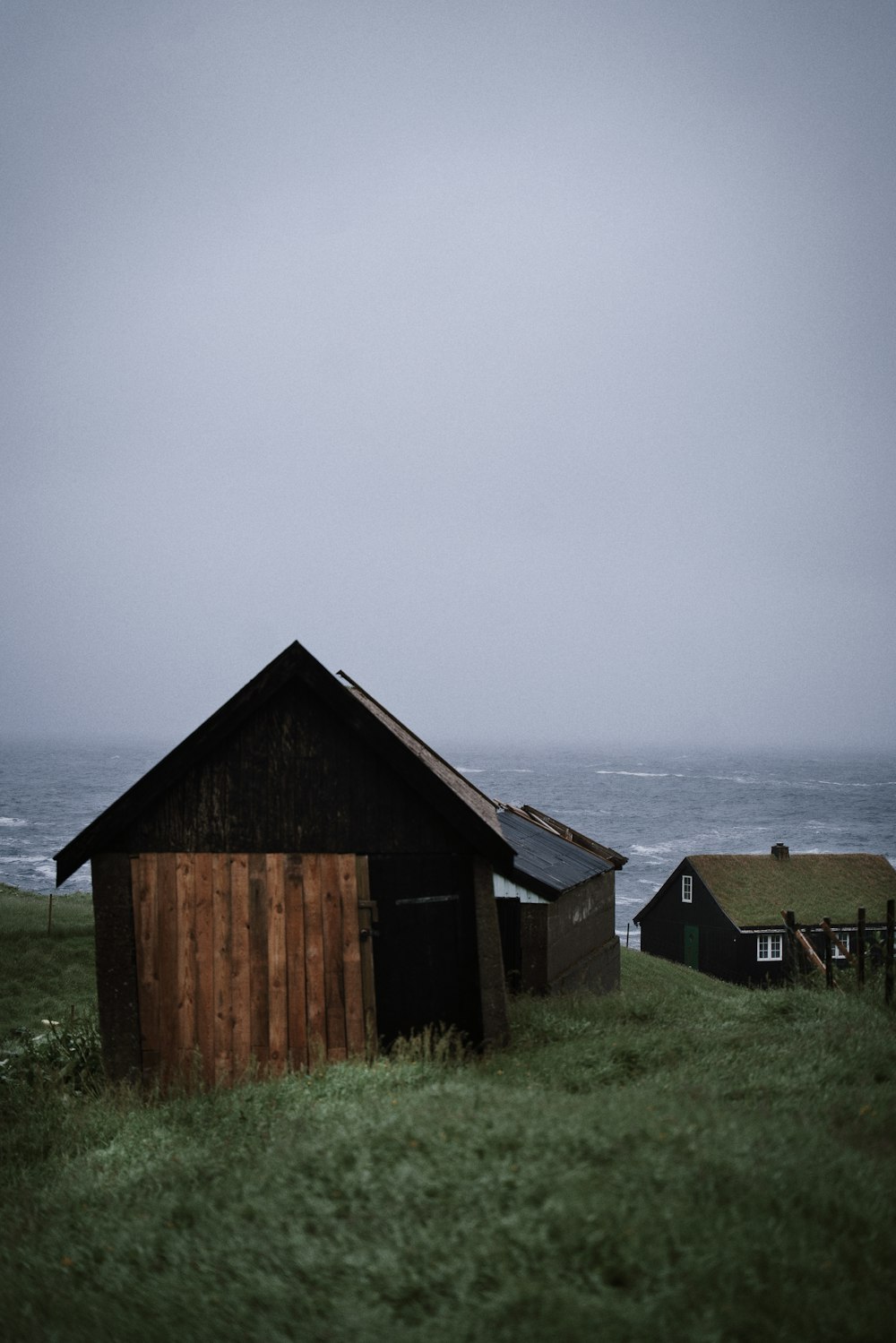 a barn sitting on top of a lush green field