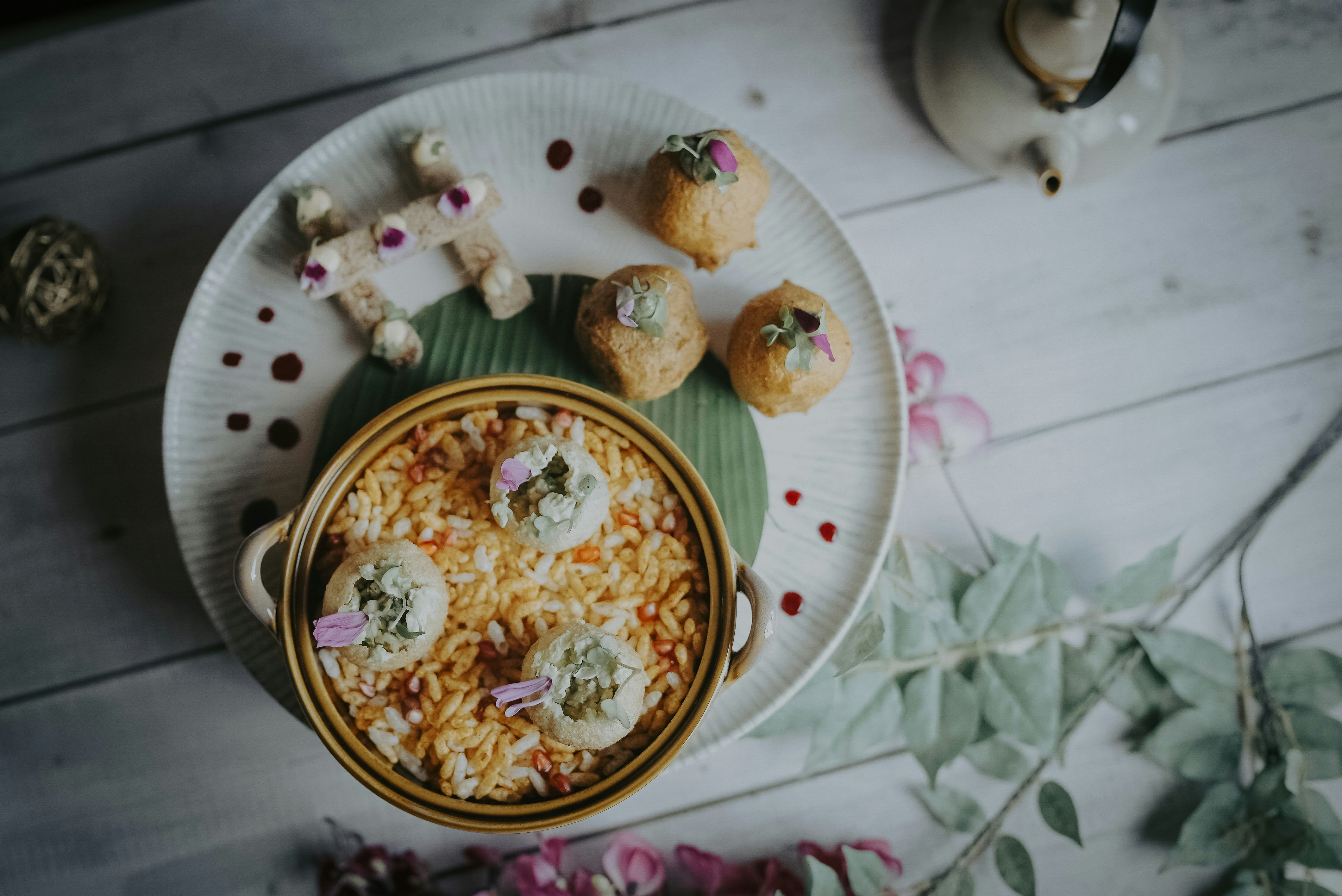 a white plate topped with food next to a cup of tea
