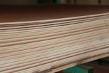 Factory floor with stacks of high-quality plywood boards ready for shipment.