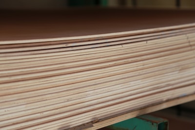 Close-up of smooth plywood sheets stacked neatly in a workshop.