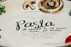 Hand-painted ceramic plate inspired by traditional Italian designs, resting on a rustic wooden table.