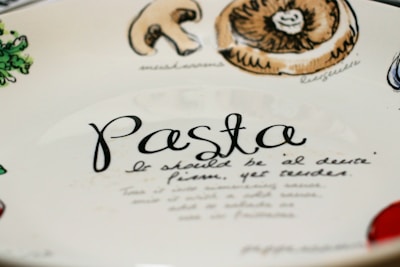Hand-painted ceramic plate inspired by traditional Italian designs, resting on a rustic wooden table.