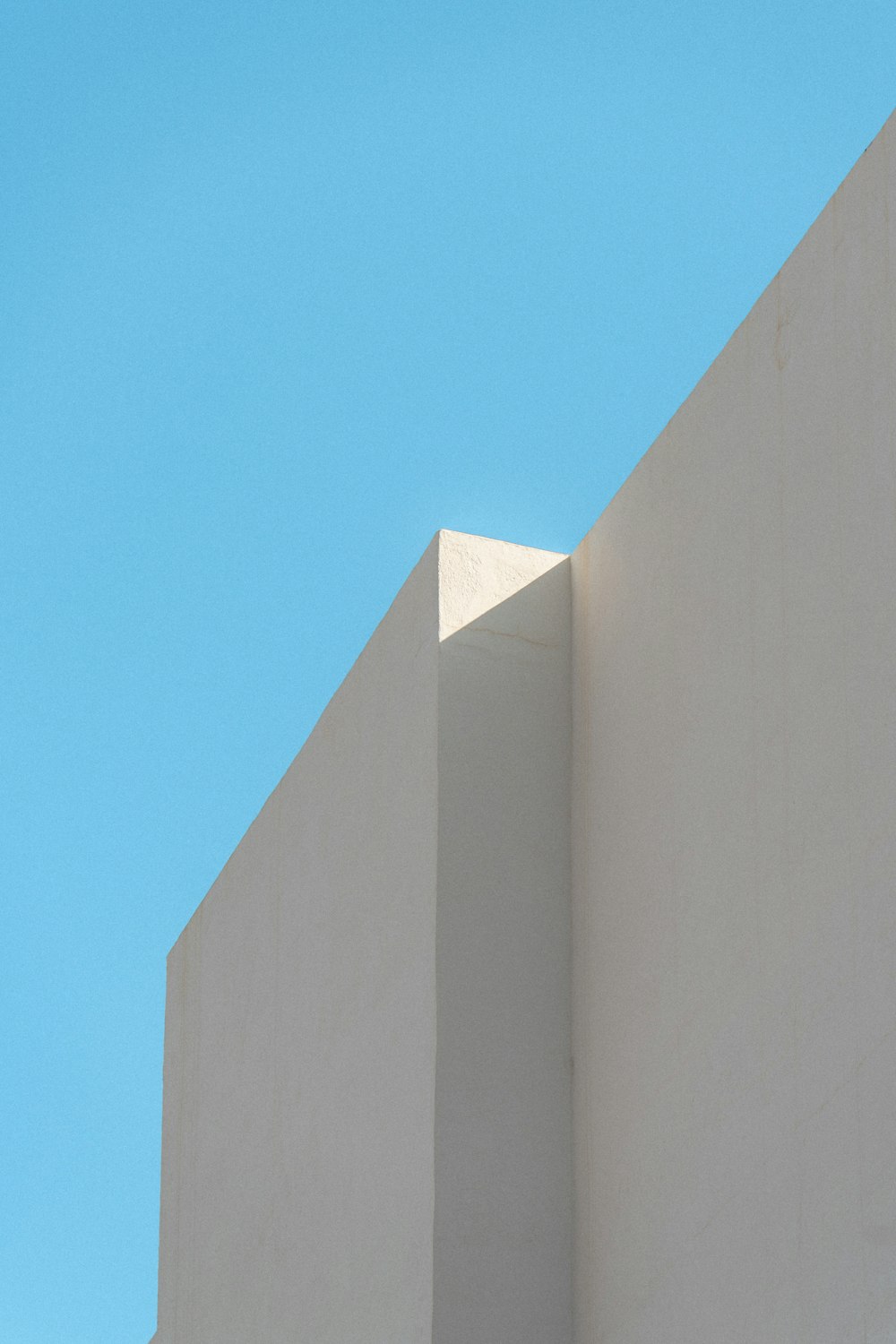 a white building with a blue sky in the background