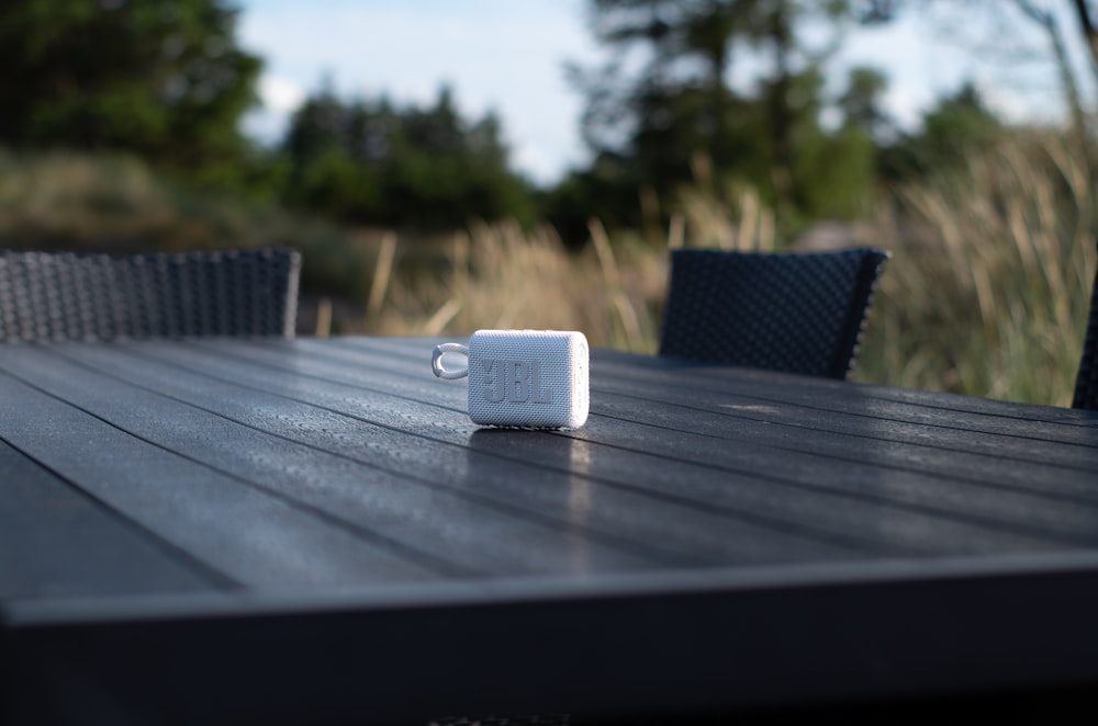 an electronic device sitting on top of a wooden table