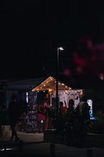 Warm evening scene with glowing lights around the dog de rua stand bustling with activity