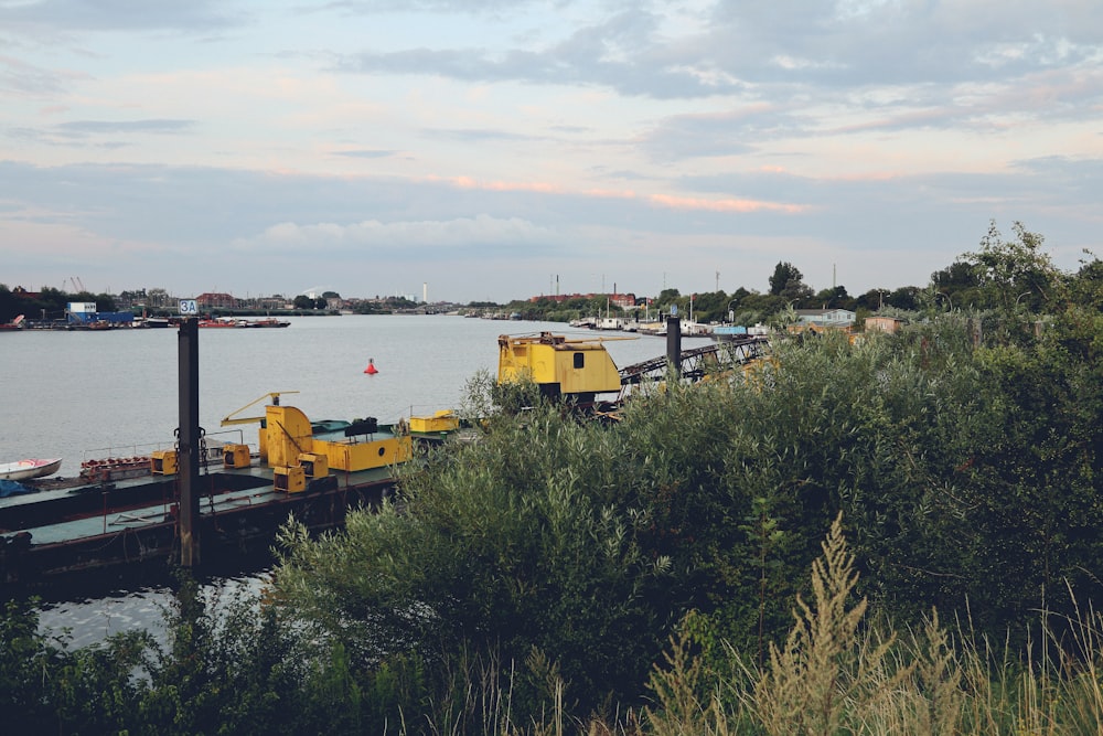 a yellow boat is docked at a pier