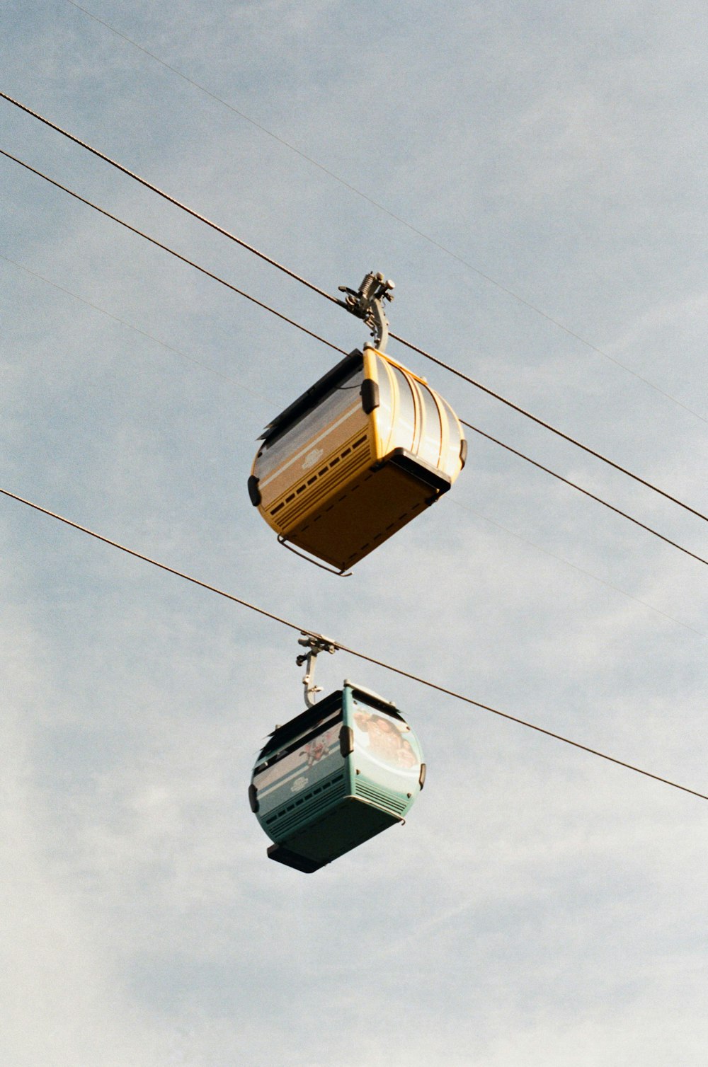 a couple of gondolas hanging from a wire