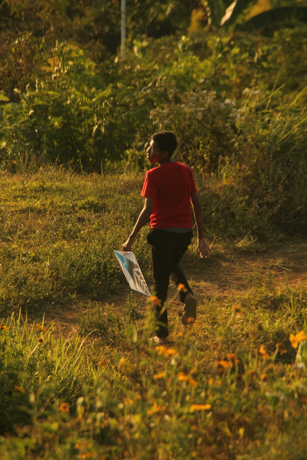 a person walking in a field with a frisbee