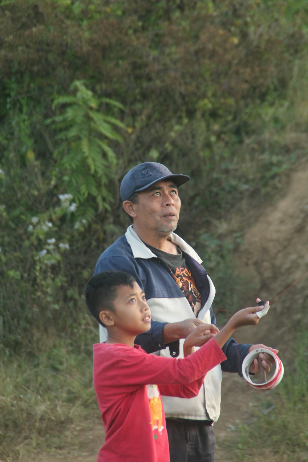 a man and a boy are playing with a frisbee