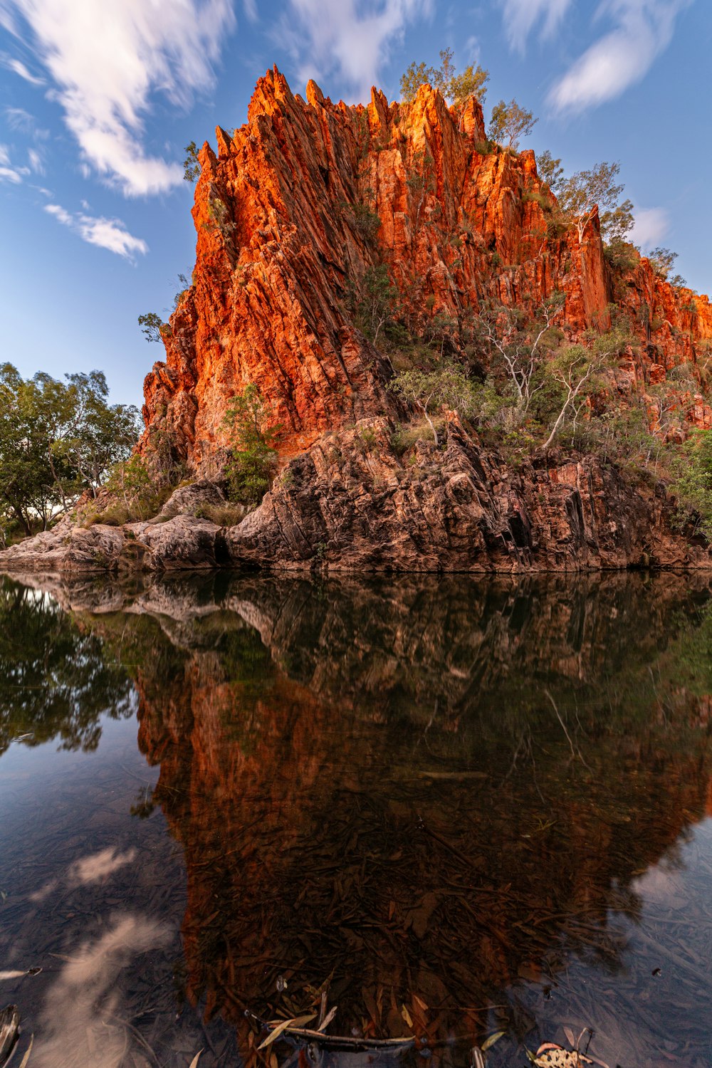 a large rock formation in the middle of a body of water