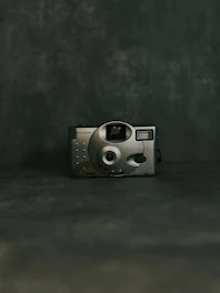 A sleek modern camera with a timeless design displayed against a minimalist background.