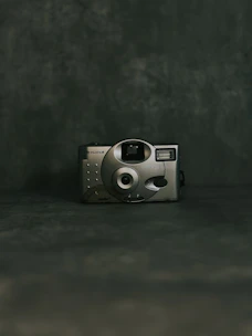 A sleek modern camera with a timeless design displayed against a minimalist background.