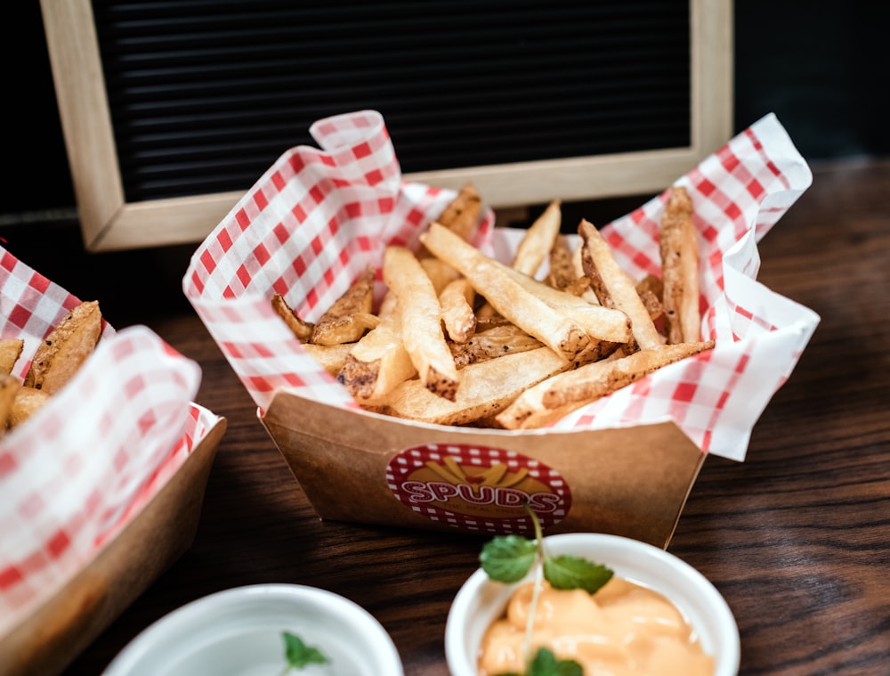 une table en bois surmontée de paniers de frites