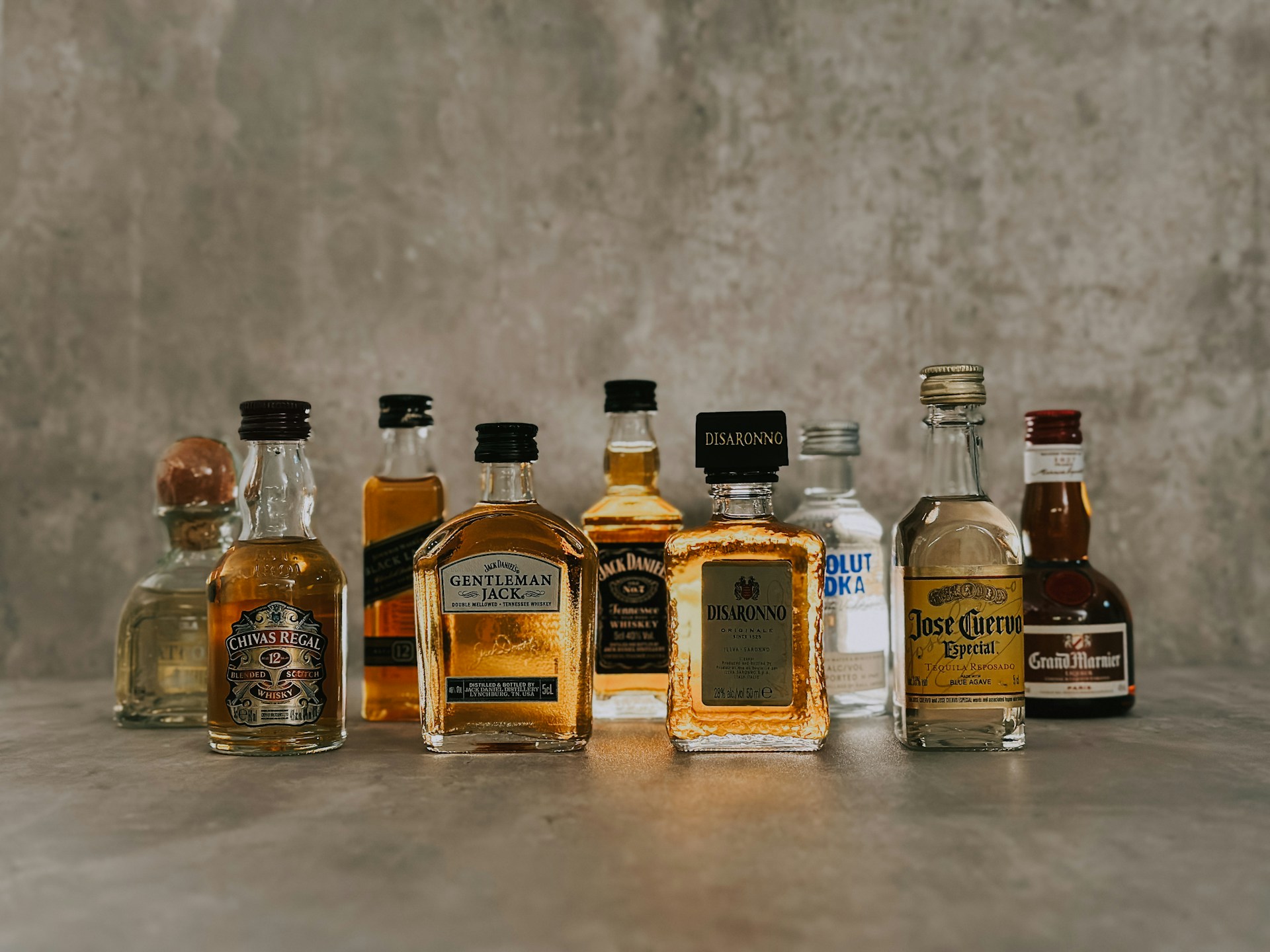 a group of bottles of liquor sitting on top of a table