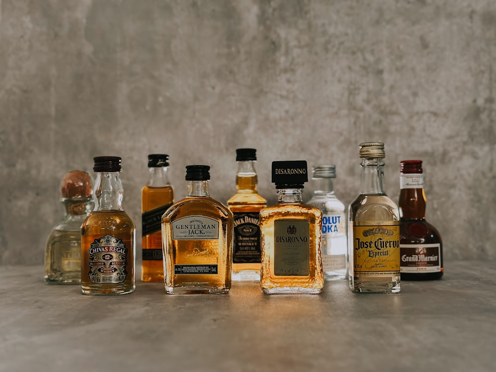 a group of bottles of liquor sitting on top of a table