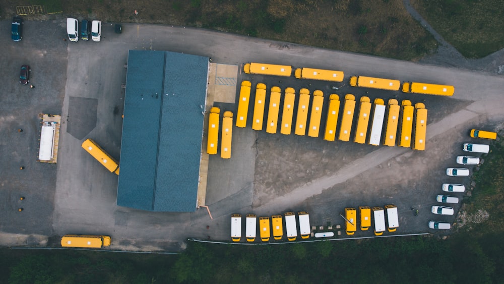 a parking lot filled with lots of yellow buses