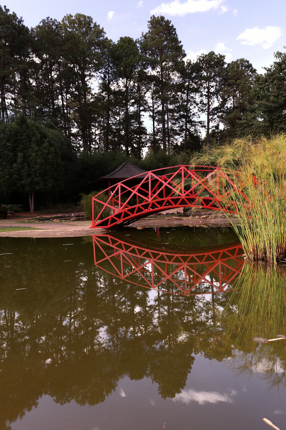 a red bridge over a body of water