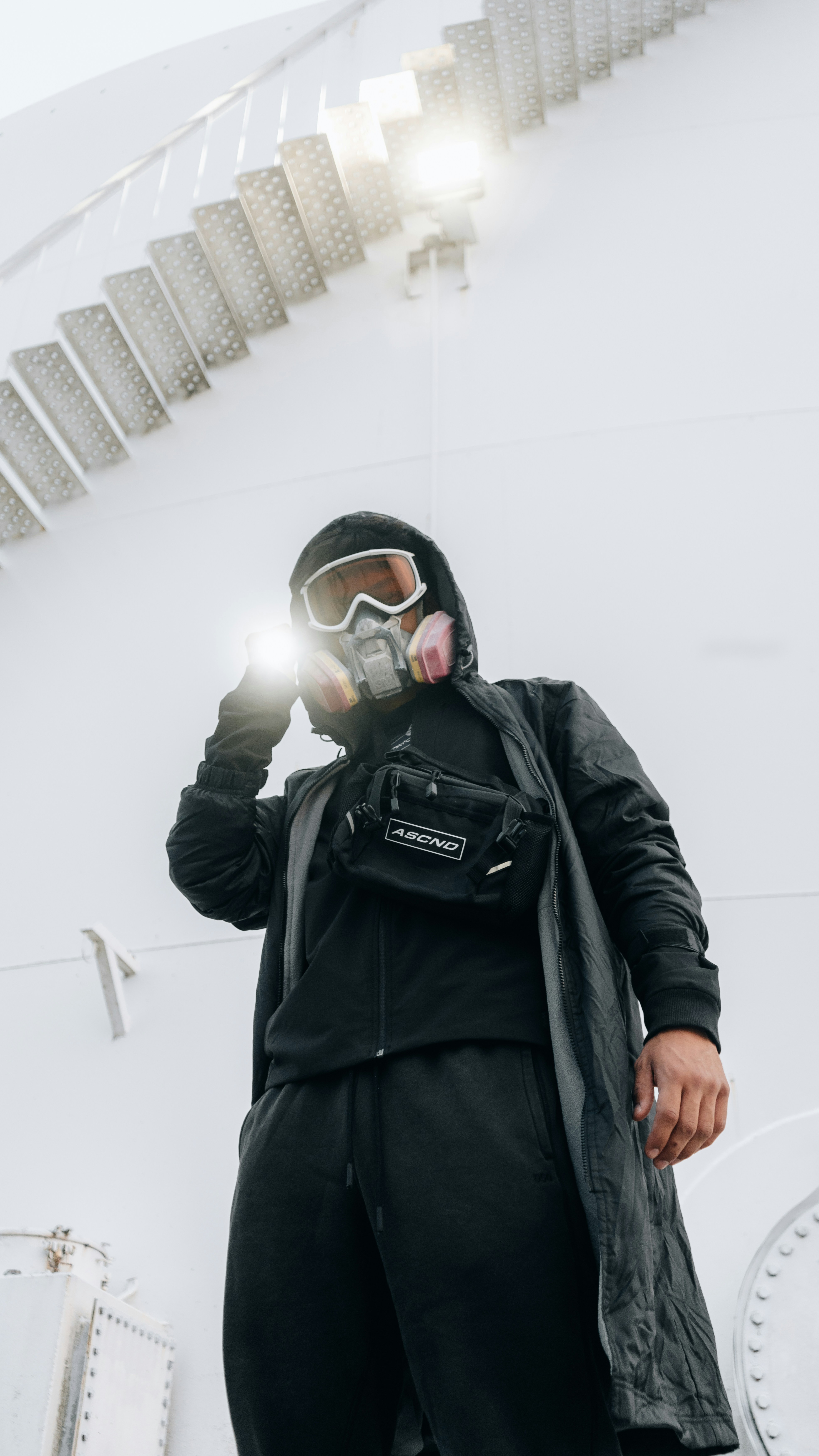 a man in a black jacket and goggles