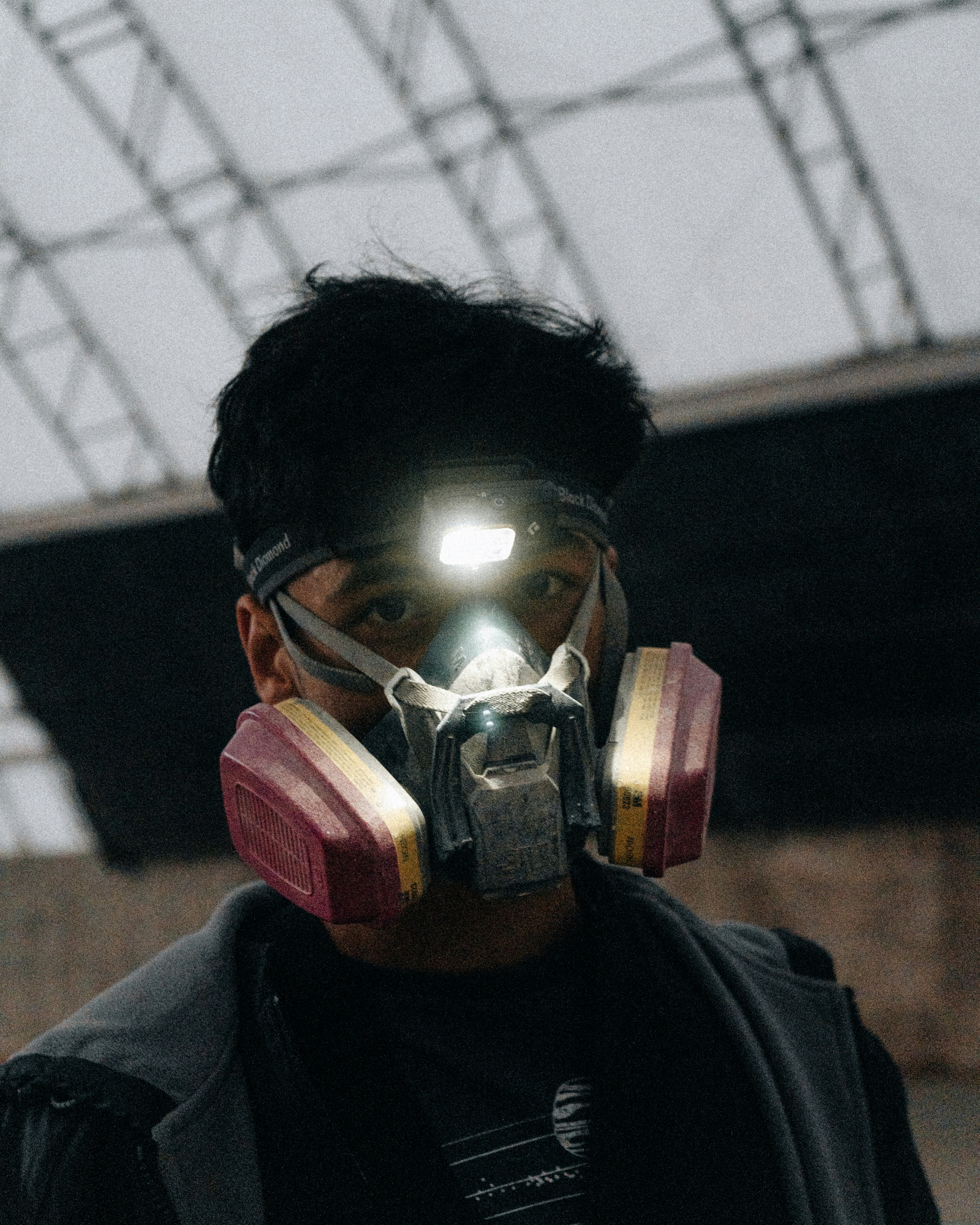 a man wearing a gas mask with a light on his face