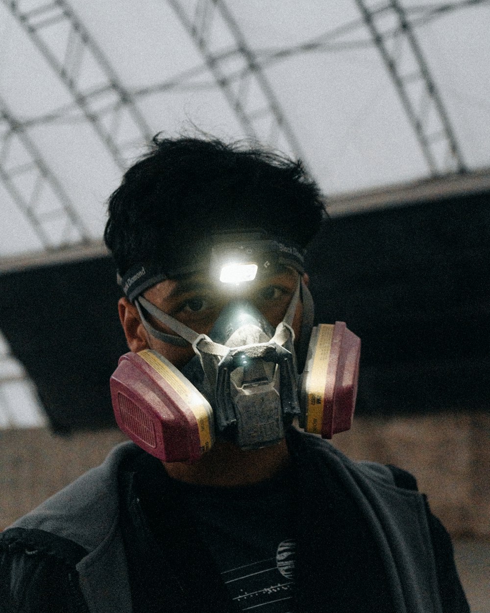 a man wearing a gas mask with a light on his face