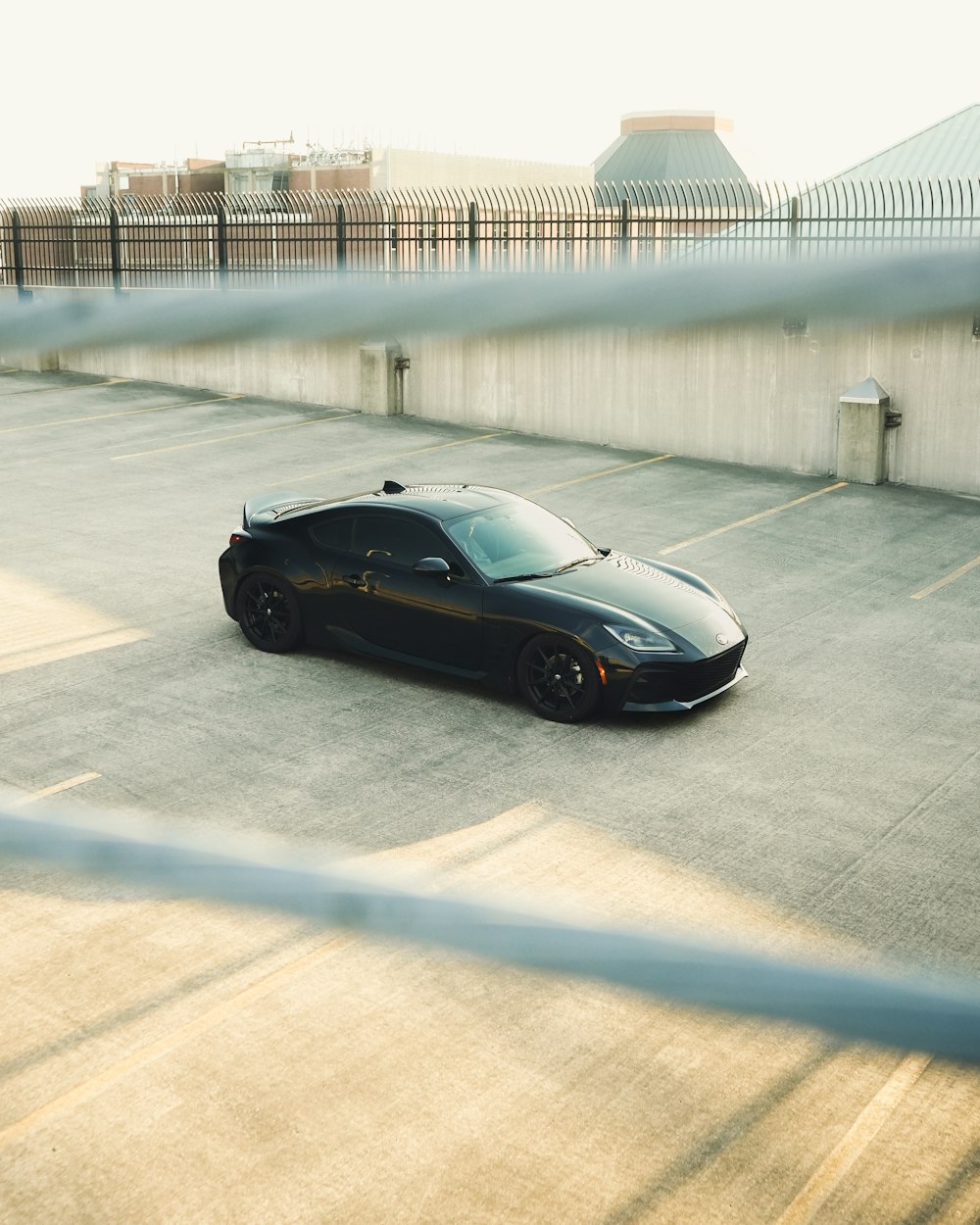 a black sports car parked in a parking lot