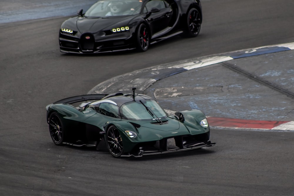 a green sports car driving down a race track