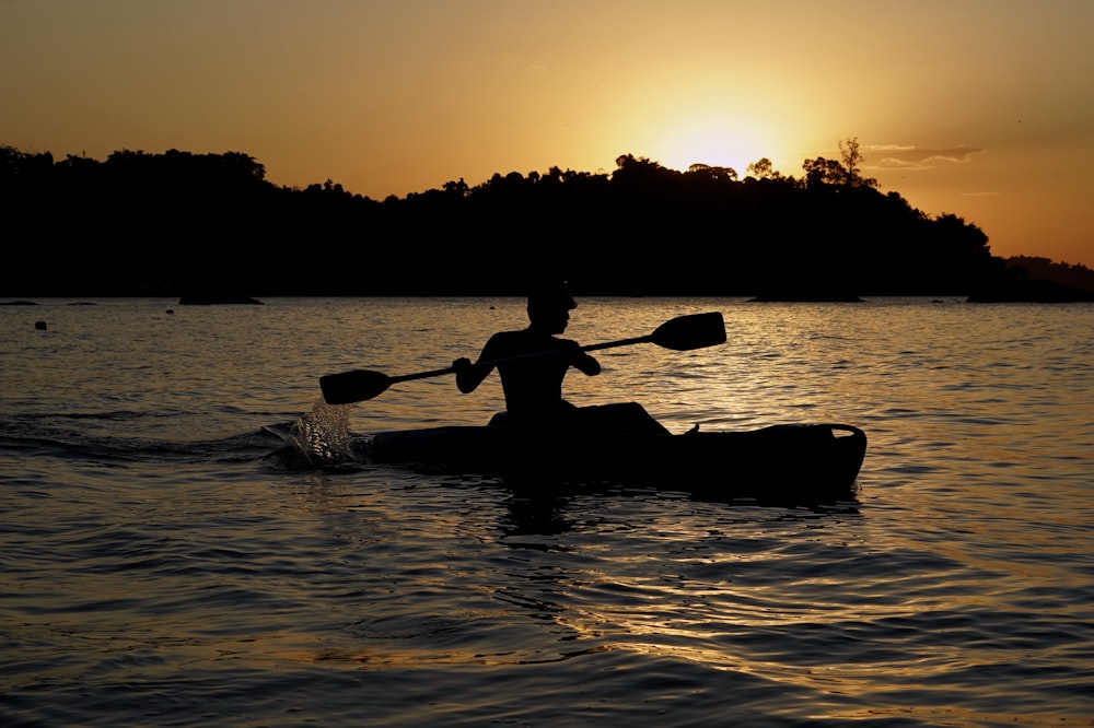 a person is paddling a canoe in the water