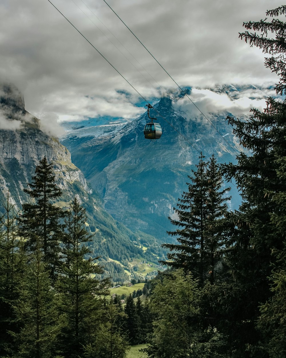 a scenic view of a mountain with a cable car