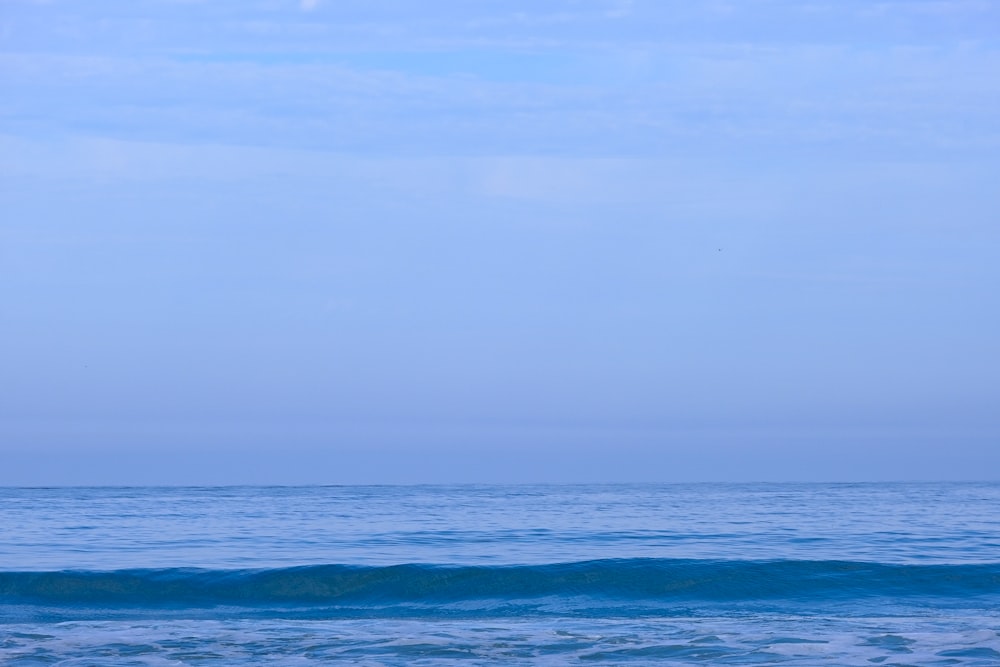 a person riding a surfboard on a wave in the ocean