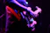 Close-up of a musician passionately playing guitar during a vibrant music video shoot.