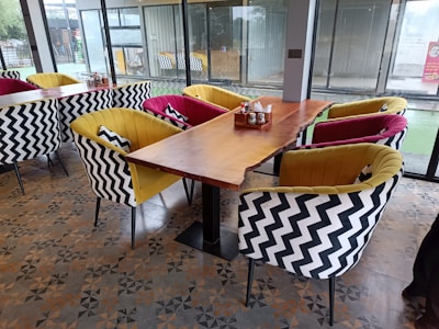 Elegant wooden dining table with matching chairs in a stylish café setting