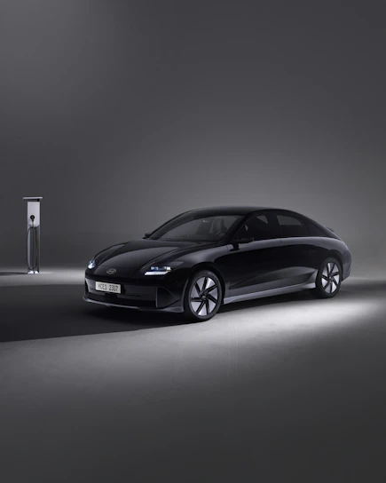 Sleek black Tesla Model S parked against a glowing Phoenix skyline at dusk, highlighting modern luxury and technology.