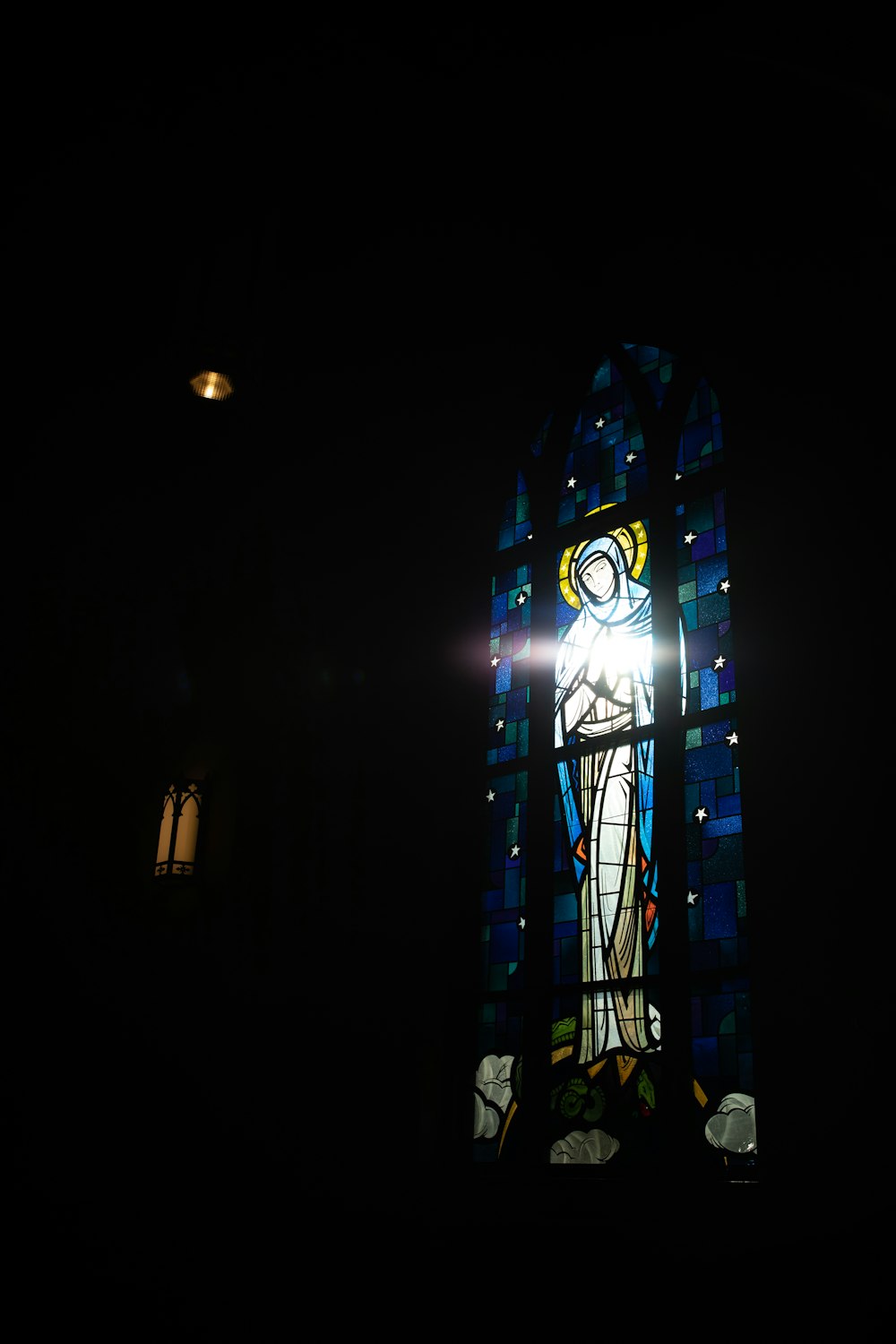 a stained glass window in a dark room