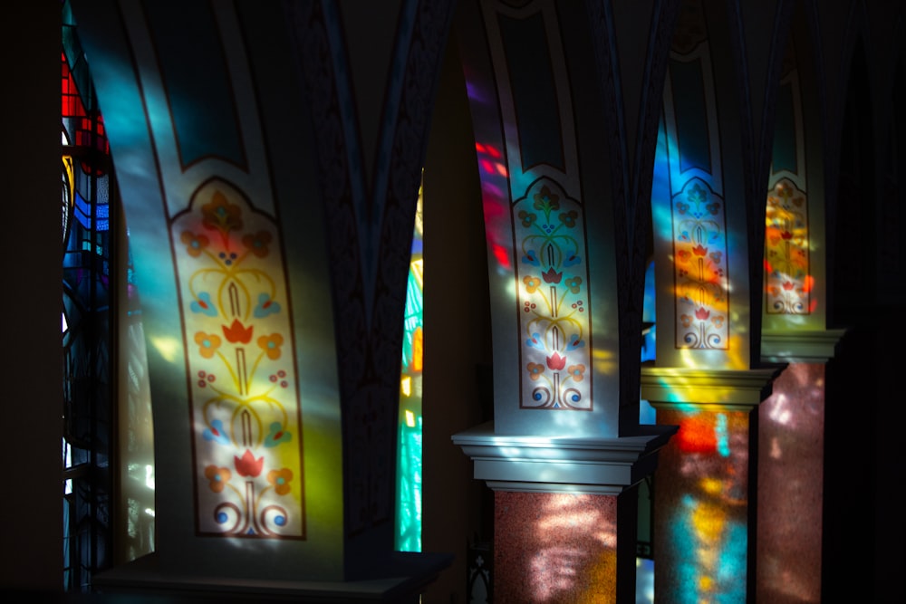 a row of stained glass windows in a church