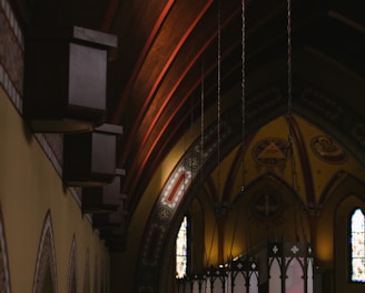 a church with stained glass windows and a wooden ceiling