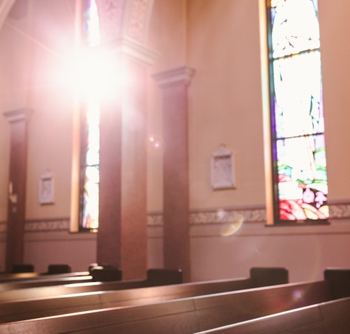 sunlight shining through a stained glass window in a church